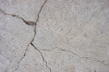 Close-up of cracked and rough concrete for overlay background.