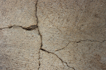 Close-up of cracked and rough concrete for overlay background.