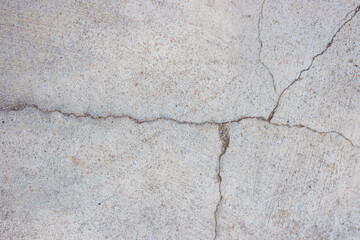 Close-up of cracked and rough concrete for overlay background.