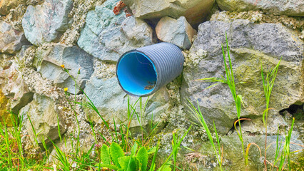 Fototapeta premium rainwater drainage pipes between the masonry stone walls