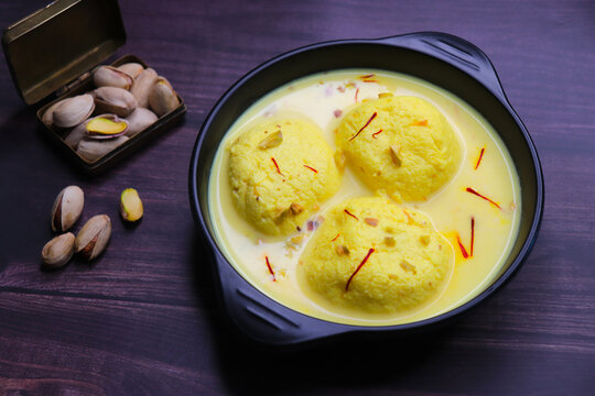 Rasmalai is a soft, spongy dessert made from chenna or paneer and soaked in creamy saffron milk, garnished with chopped pistachios and almonds. A festive Indian sweet, chilled and served in syrup.