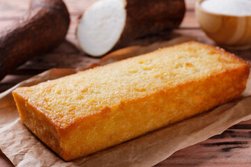 Traditional homemade cassava cake whit coconut on a rustic wooden table