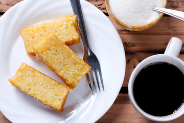 Traditional homemade slices cassava cake whit coconut on a rustic wooden table