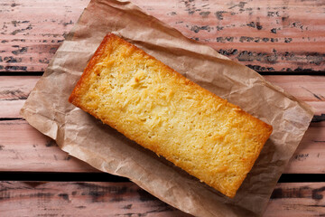 Traditional homemade cassava cake whit coconut on a rustic wooden table