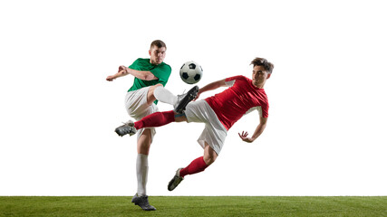 Soccer players in green and red jerseys kicking ball in midair during intense match on grass....