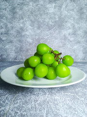 Shine muscat grapes on a white plate