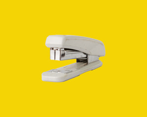 stapler isolated on yellow background