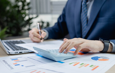 Tax deduction planning concept. Businessman calculating financial balance, preparing documents for...