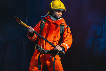 firefighter in an orange suit holding  long pole