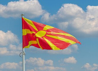 North Macedonian textile national flag waiving in the wind outside in the park