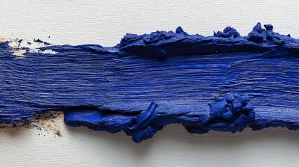 Bold vibrant blue paint stroke with textured ridges on white canvas, closeup view capturing natural bristle marks and dynamic brushwork, artistic detail and dramatic contrast