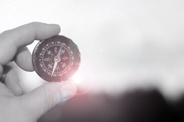 Classic navigation compass in your hand on natural background