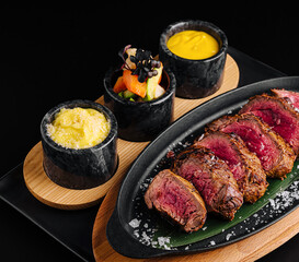 Grilled steak with fresh veggies and sauces at a fine dining spot