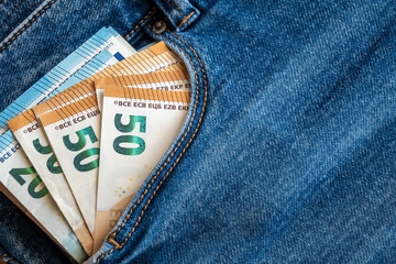 Pocket in jeans with money, much bills. Business concept.