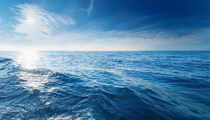 Fototapeta premium calm ocean waves with sunlight reflections on a clear day serene water surface peaceful nature scene soft blue and white tones aquatic environment