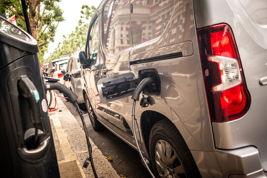 An electric van EV on charge on an urban city street