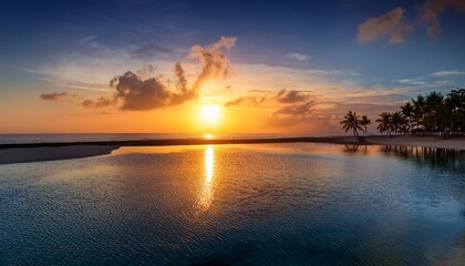 Obraz premium as sun gracefully ascends casting its golden glow upon tranquil oasis horizon becomes a canvas of vibrant hues dancing reflections on glistening water evoking a sense of rejuvenation and endless p