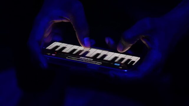 Music Producer&rsquo;s Hands on Mobile MIDI Controller &ndash; Blue Neon Light