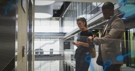 Colleagues tapping smartphone and calling elevator while business tech nodes growing around them