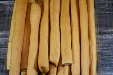 Breadsticks, also known as grissini, grissino or dipping sticks, pencil-sized sticks of crisp, dry baked bread, There is also a soft-baked breadstick version, rusk, bread crunch crackers