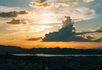Sunset over West Lake in Hangzhou with dramatic clouds and cityscape views