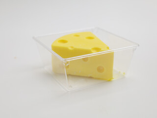 Cheese shaped cheesecake on plastic container