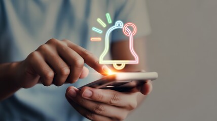 Person using smartphone with glowing notification bell icon hands mobile phone