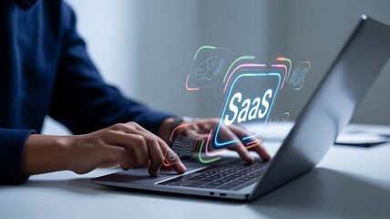 Person typing on laptop with Saa S and cloud technology icons glowing hands SaaS