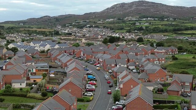 Welsh townhouse modern property aerial view flying across the rocky mountain neighbourhood