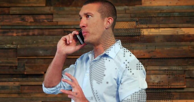 Business executive holding smartphone making call against wood wall with dot pattern overlay