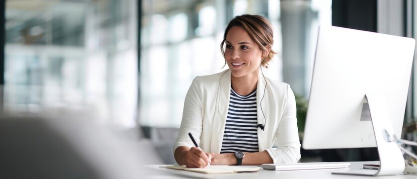The focused woman engaged in creative work at a modern office desk