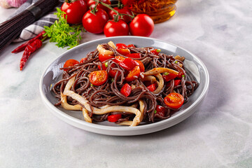 Black rice pasta with squid and tomato