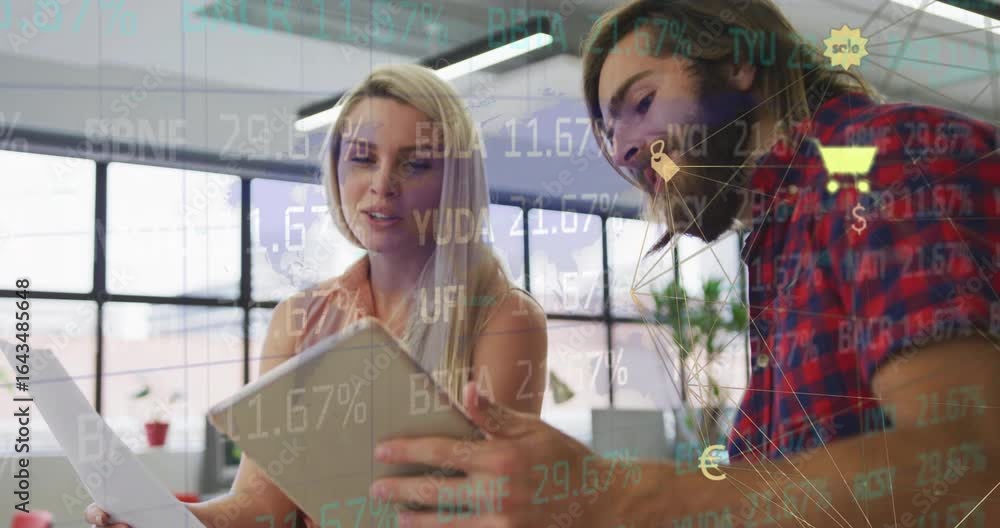 Poster co-workers tilting tablet causing financial chart overlays updating, supporting data analysis