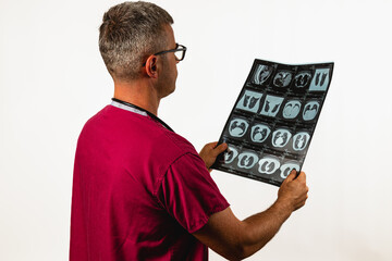 Medical professional examines chest X-rays in clinical setting