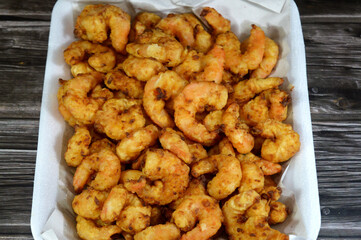 Fried shrimps covered with flour and fried in deep hot oil, shrimps are crustacean (a form of shellfish) with an elongated body and a primarily swimming mode of locomotion, Caridea or Dendrobranchiata