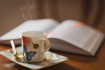 Relaxing moment with coffee and book on a cozy table during a quiet afternoon
