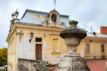 Historic building with ornate stone details under overcast sky in a serene landscape