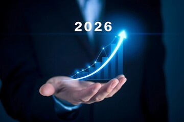 Businessman holding a glowing arrow pointing upwards towards the year 2026 symbolizing future growth and success