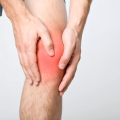 Close-up of a person holding their inflamed knee.