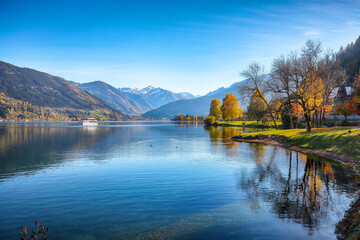 Amazing autumn view of lake and trees in city park of Sell Am See