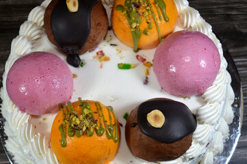 Ice cream cake Cassata, vanilla, whipped cream, milk, filled with dried fruit, topped with mango...