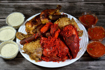 cooked chickens, ,Tandoori juicy chicken, roasted chicken and original one, cooked in a pressure cooker with a mix of special spice, red and yellow Basmati rice, Daqos sauce and Yoghurt salad