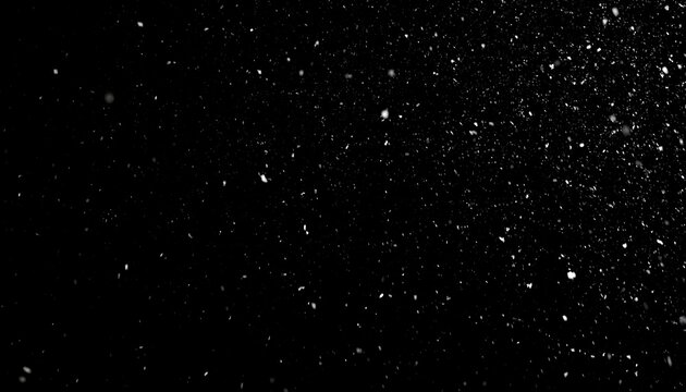 Abstract snowfall particles against dark background