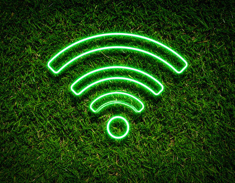 Neon green wifi symbol on a grassy surface.