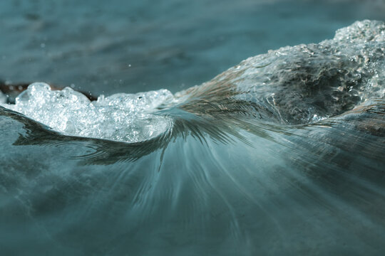 View of the shimmering, turquoise water swirls and dances, catching the sunlight in a mesmerizing aquatic ballet, Saturnia, Tuscany, Italy.