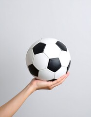 Fototapeta premium Hand holding soccer ball