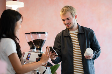 Closeup shot of cashier hands. Seller using touch smartphone for accepting client customer payment.