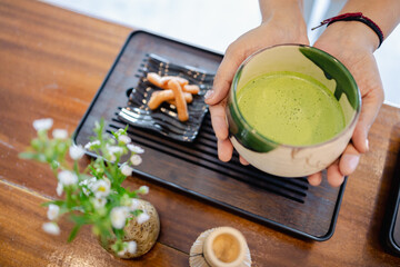 Green tea cup traditional culture japanese style matcha bowl snack wooden table flower vase...
