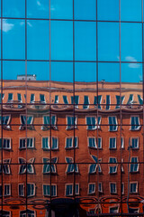Reflection of an old building in the windows of a modern art