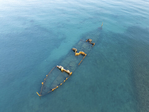 Aerial view of a tranquil shipwreck submerged in clear blue ocean waters, Bain des Dames, Port Louis, Mauritius.
